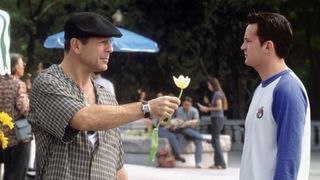 Bruce Willis gives a flower to Matthew Perry in The Whole Nine Yards