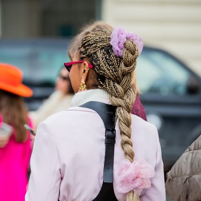 A guest is seen with scrunchies outside Stine Goya during Copenhagen Fashion Week Autumn/Winter 2022 on February 02, 2022 in Copenhagen, Denmark