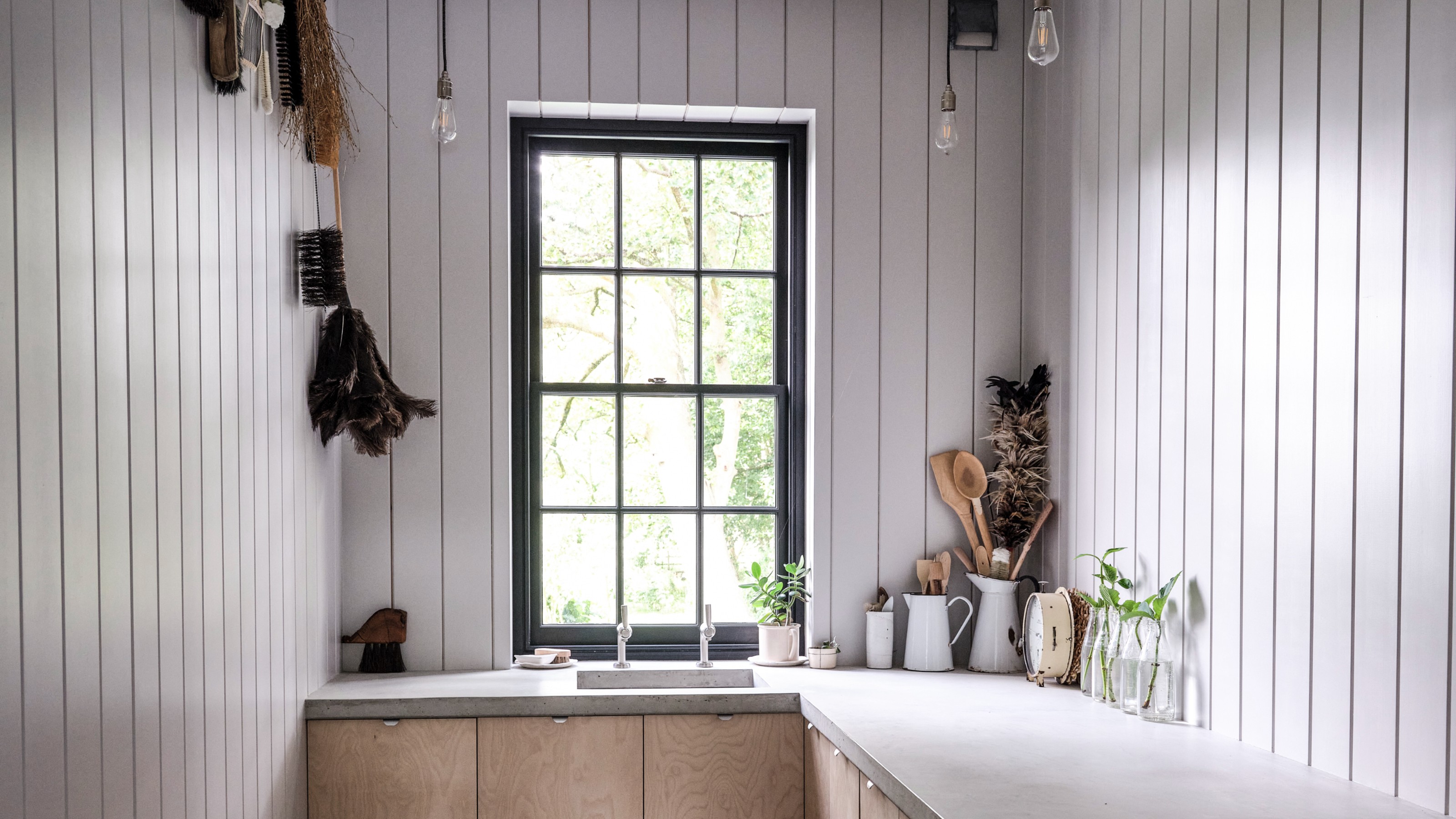 A fully panelled white kitchen with plywood cabinets