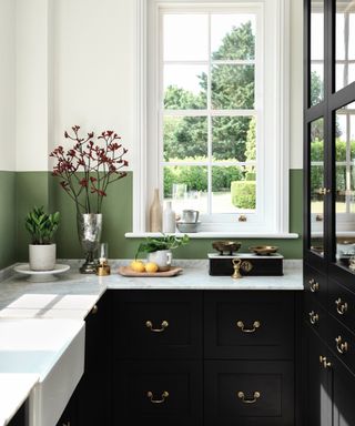 colors that go with dark green, black and white small kitchen with green painted backsplash, window to garden black cabinetry, marble countertops
