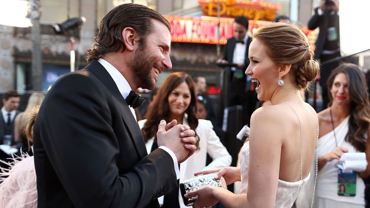 Bradley Cooper and Jennifer Lawrence share a moment of laughter on set