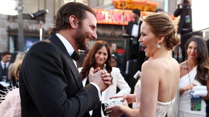 Bradley Cooper and Jennifer Lawrence share a moment of laughter on set