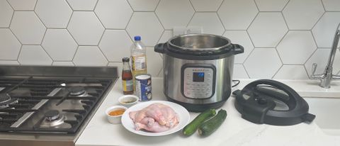 Instant Pot Duo Crisp & Air Fryer on a kitchen countertop with the ingredients to cook a chicken curry