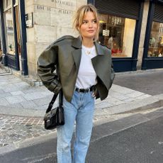 A French girl wearing a leather jacket and jeans