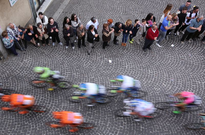 The peloton rushes by