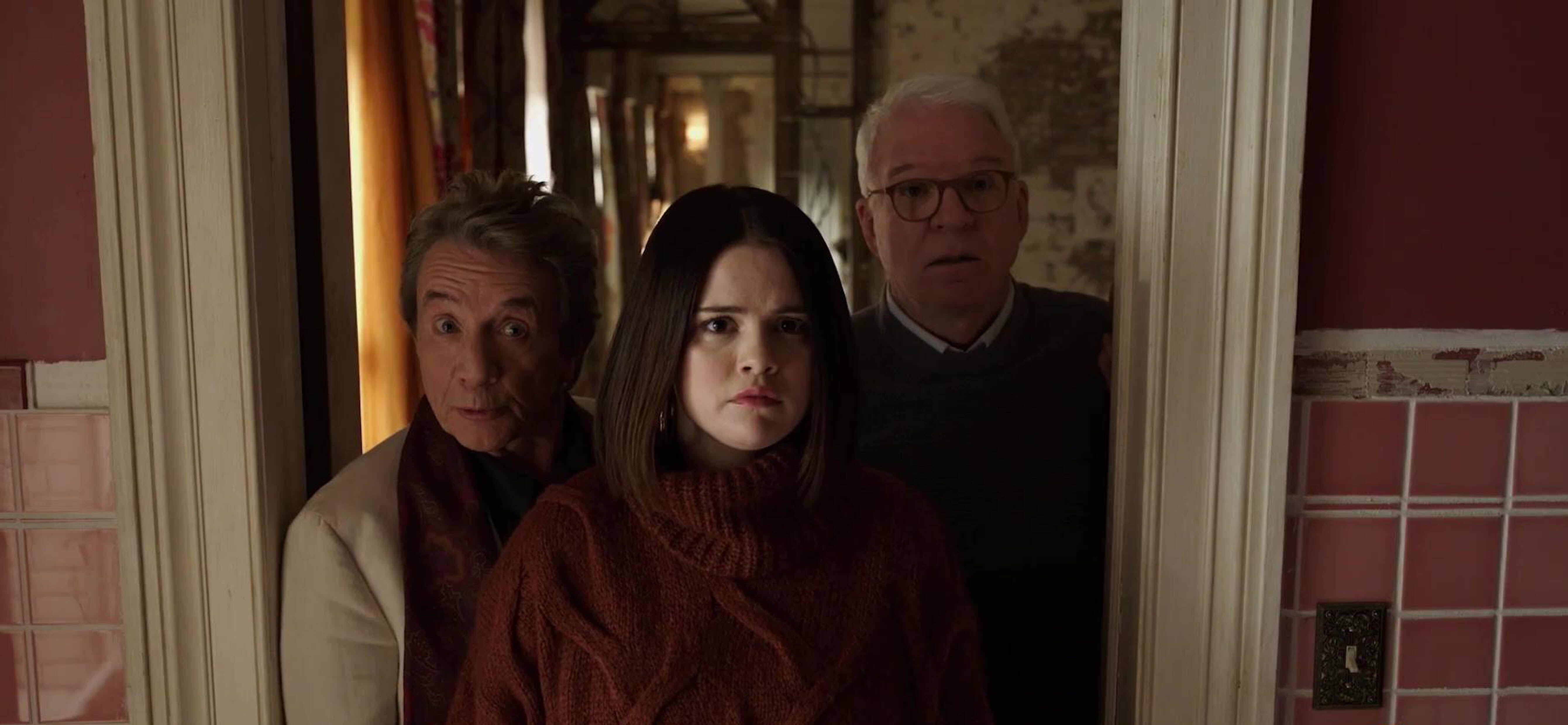 Martin Short, Selena Gomez, and Steve Martin as oliver, mabel, and charles looking out a window in the arconia in &#039;Only Murders in the Building&#039;