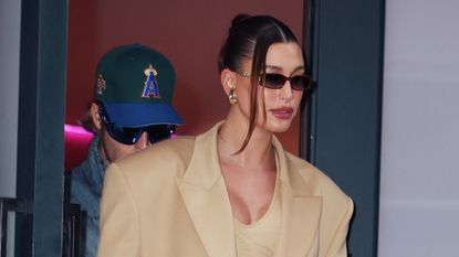 Hailey Bieber walking in new york city wearing an oversize blazer and matching dress