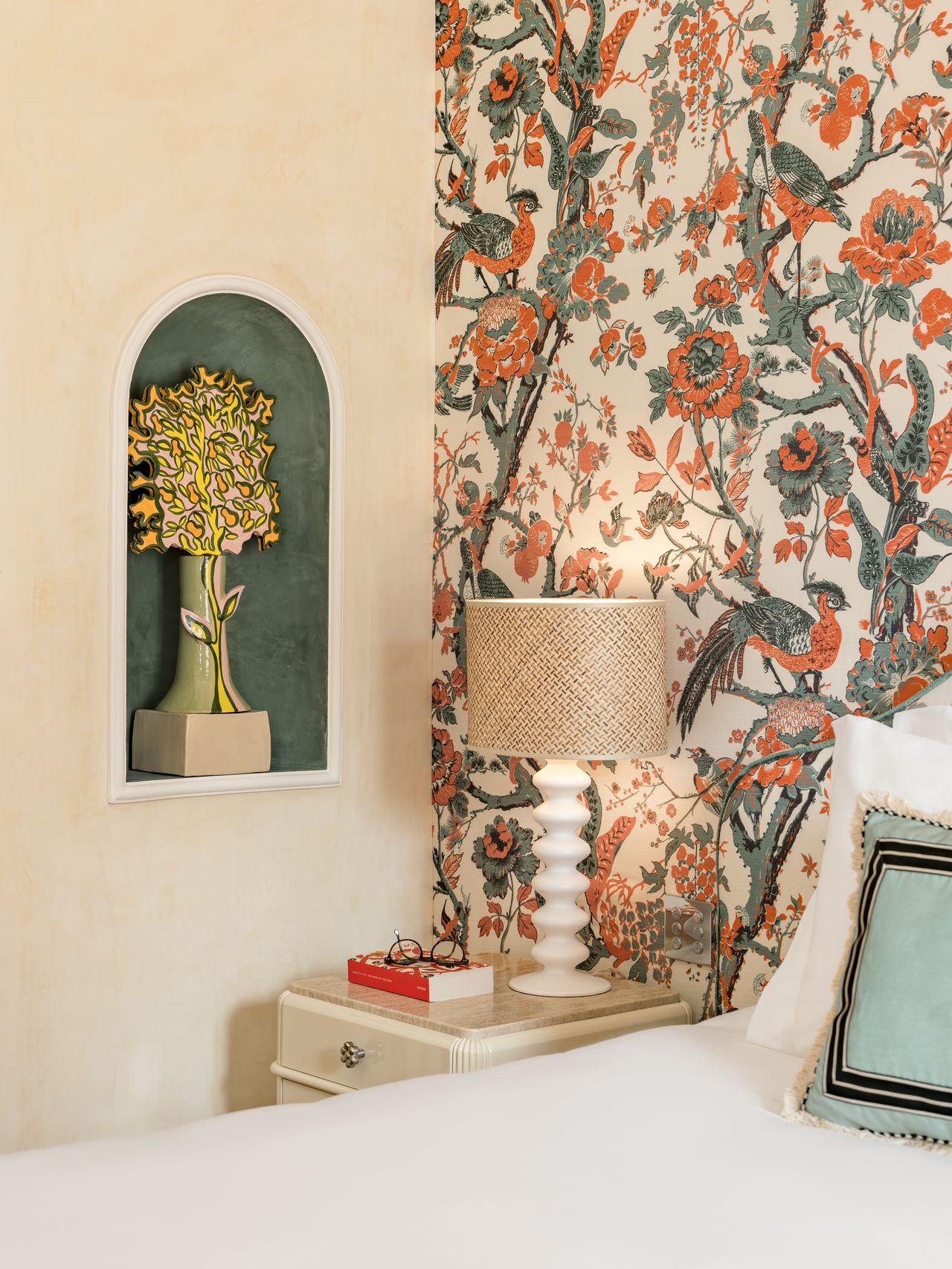 An art-filled hotel room features maximalist design, including countless artworks and contrasting surfaces.