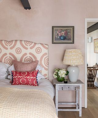 pink bedroom in 19th century Dorset barn conversion with colorful interior