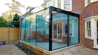 glass box extension to a traditional brick home