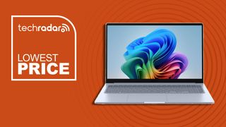 white laptop against orange background