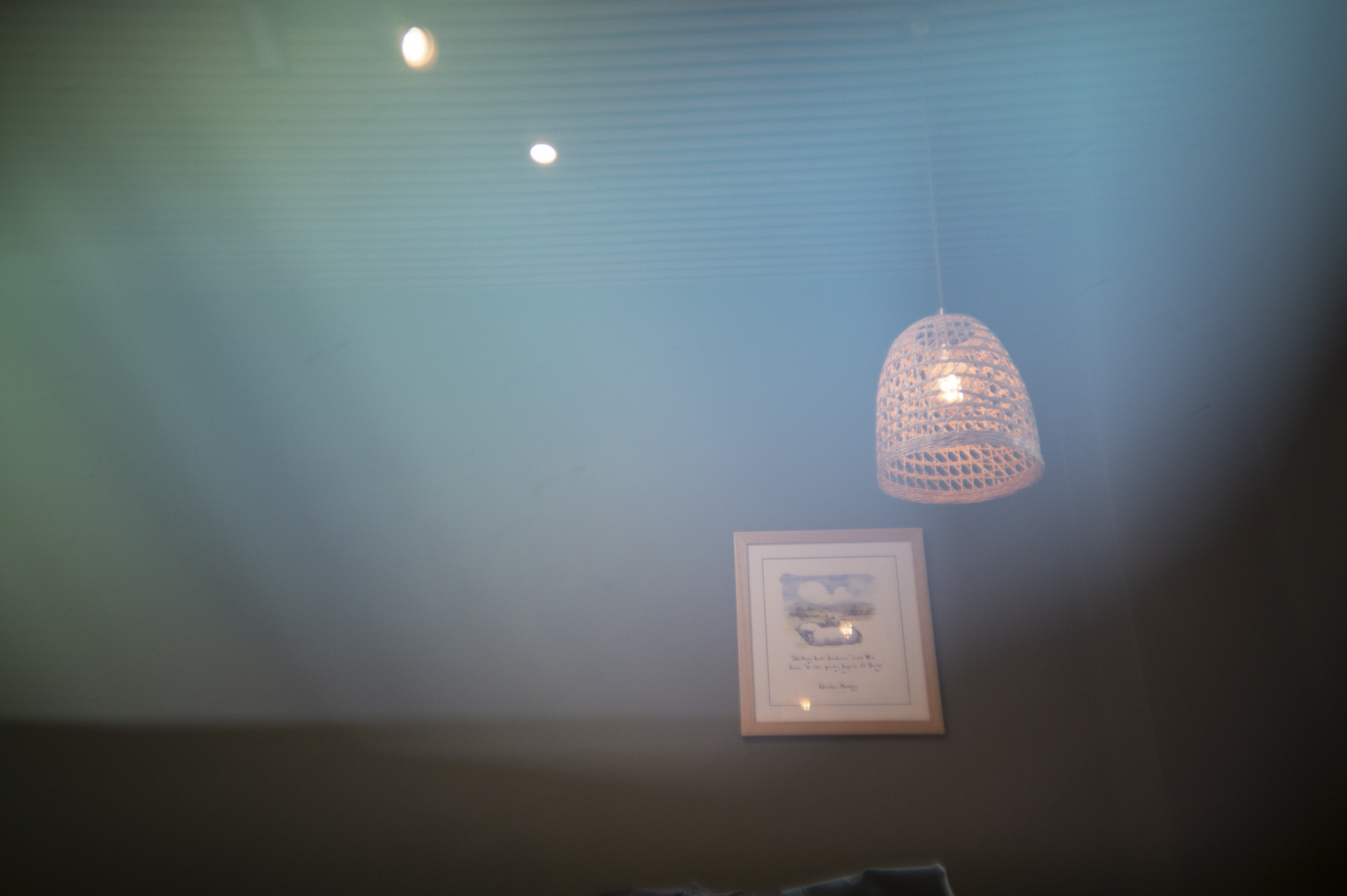 A lamp shade inside a cafe, with light leak effect