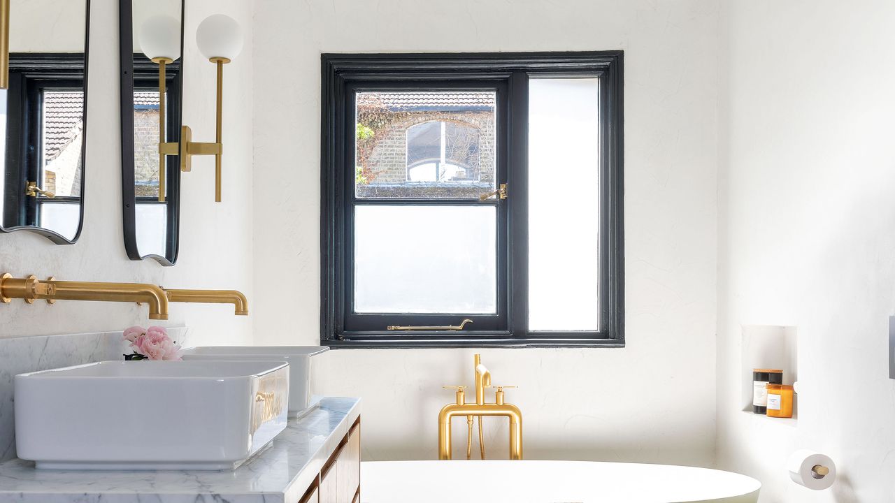 Bathroom with partially blocked out window over bath