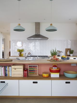 Modern kitchen with large island unit and white herringbone wall tiles
