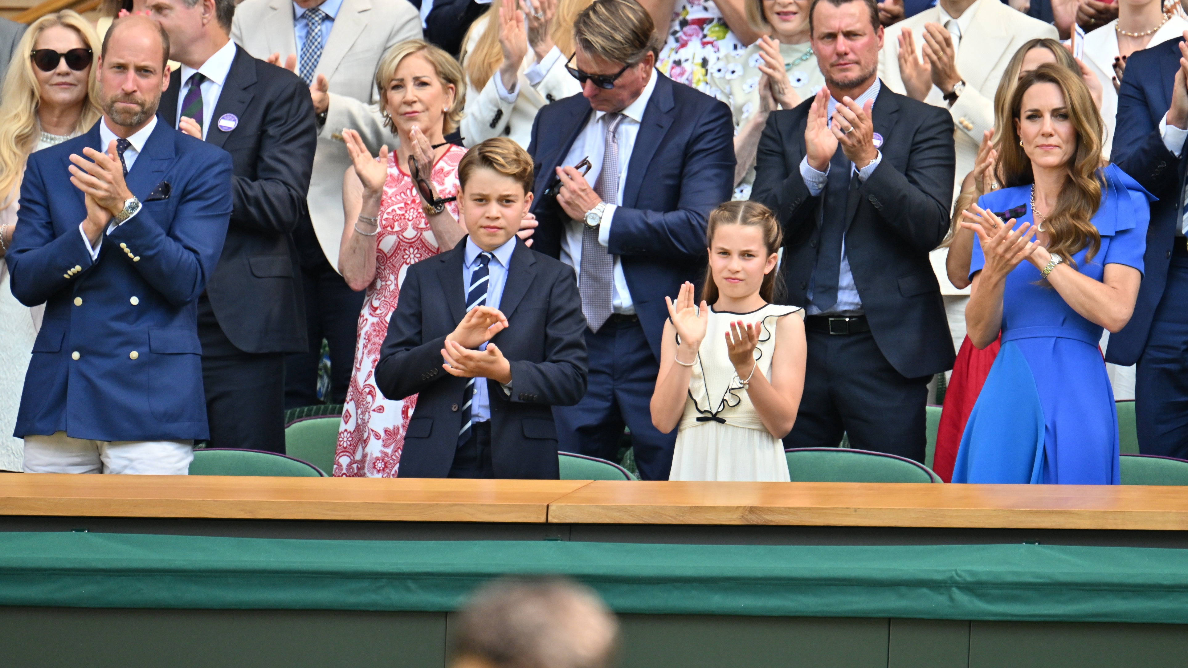 The Princess of Wales, Princess Charlotte, Prince George and William, Prince of Wales clap as they attend day fourteen of the 2025 Wimbledon Championships