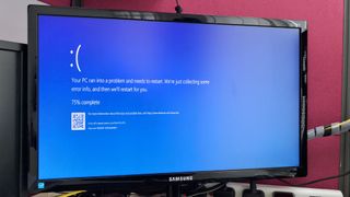 The Blue Screen of Death (BSOD) error screen as shown on a Samsung monitor in an office
