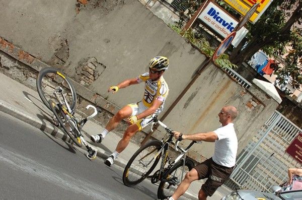 Mark Cavendish gets a bike from the team mechanic after he crashed with Yohann Gene.