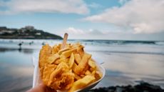 fish and chips in front of a beach