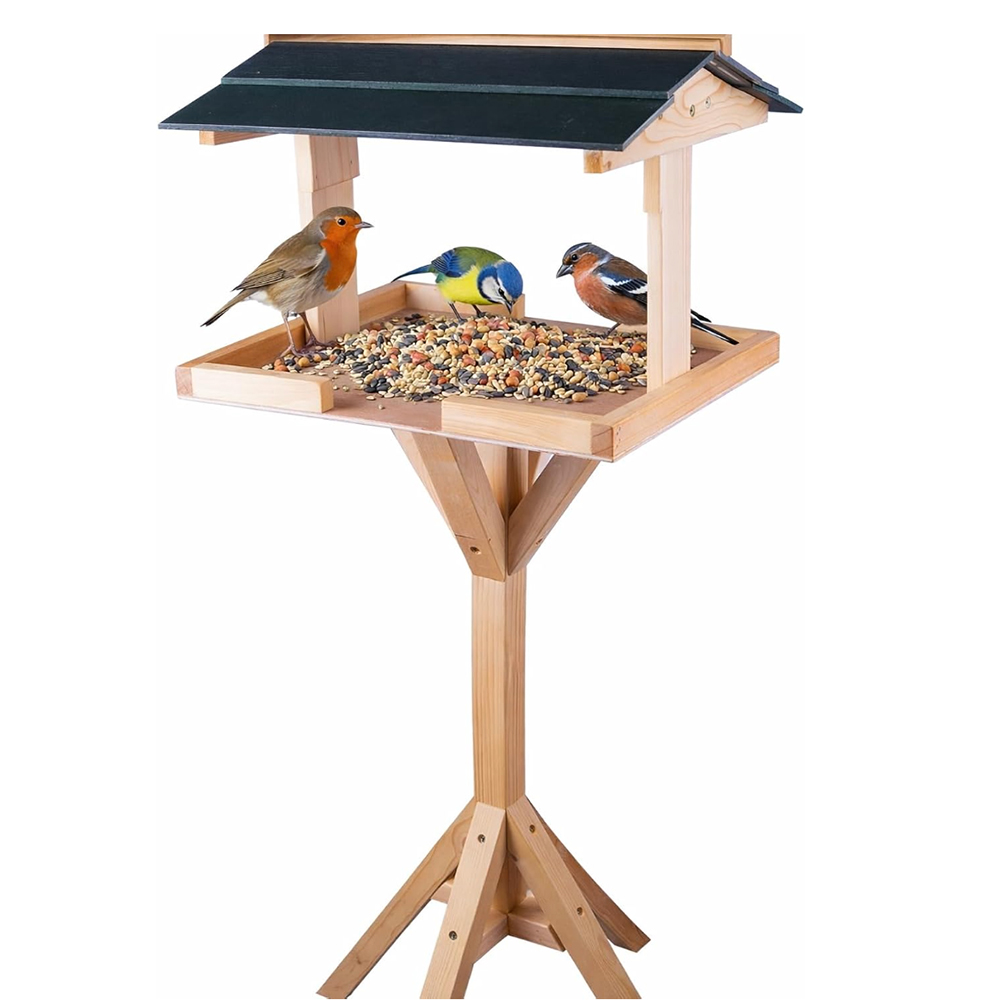 Sheltered bird table with a roof over bird seed with birds feeding