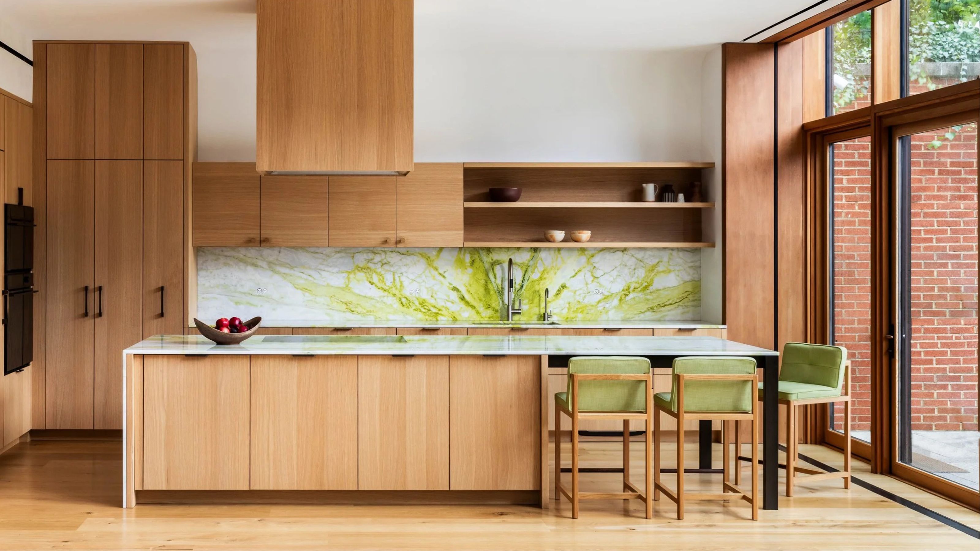 chartreuse marble backsplash in timber kitchen with green barstools and white ceiling
