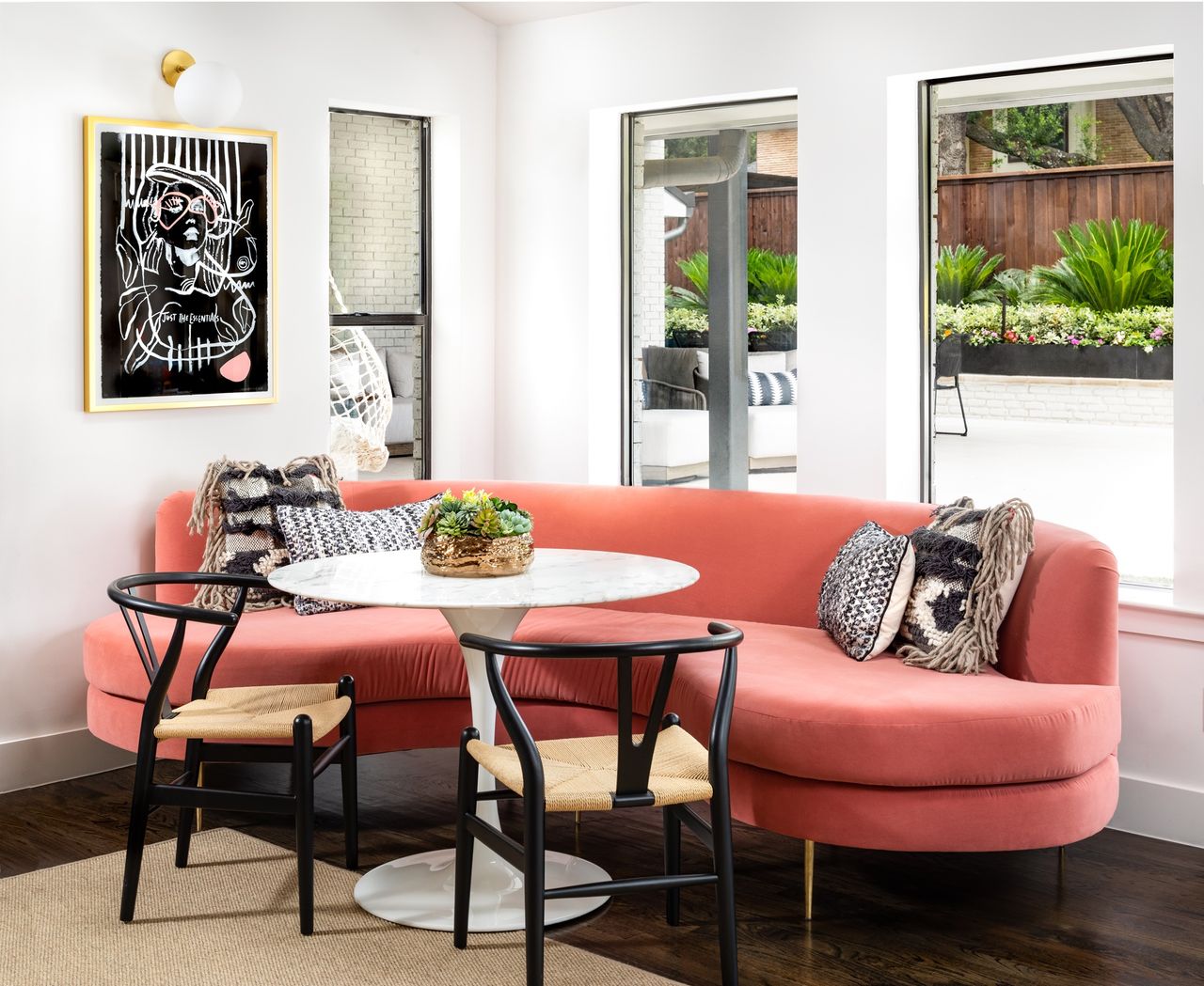 Dining nook in kitchen with red sofa by Maestri Studio