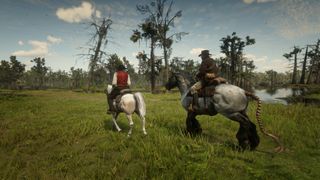 Arthur and Dutch riding horses through a swamp in Red Dead Redemption 2.