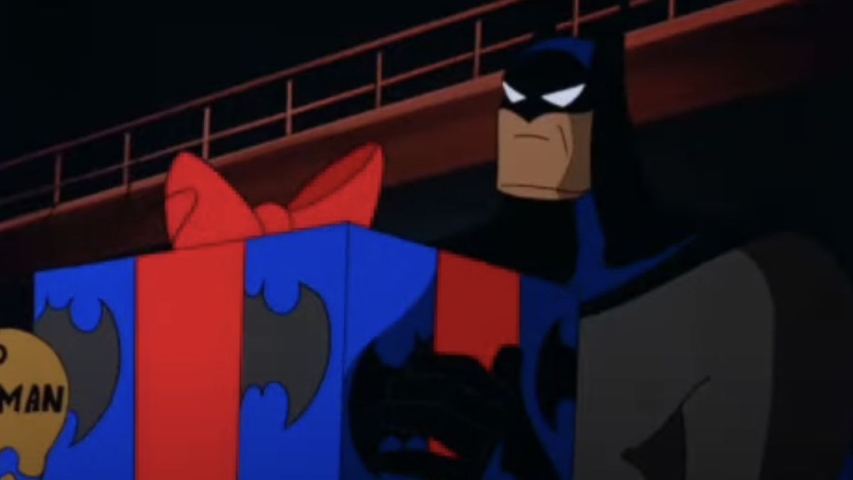 Kevin Conroy as Batman holding a holiday gift on Batman: The Animated Series