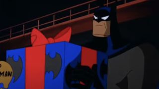 Kevin Conroy as Batman holding a holiday gift on Batman: The Animated Series