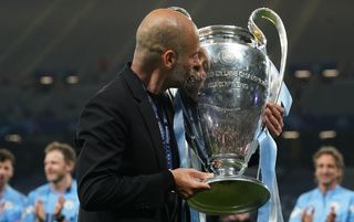 Manchester City manager Pep Guardiola kissing the Champions League trophy