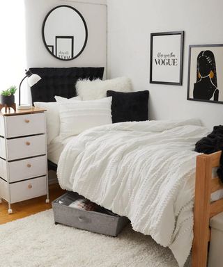 A student bedroom with white wall paint decor, framed wall art and black framed mirror