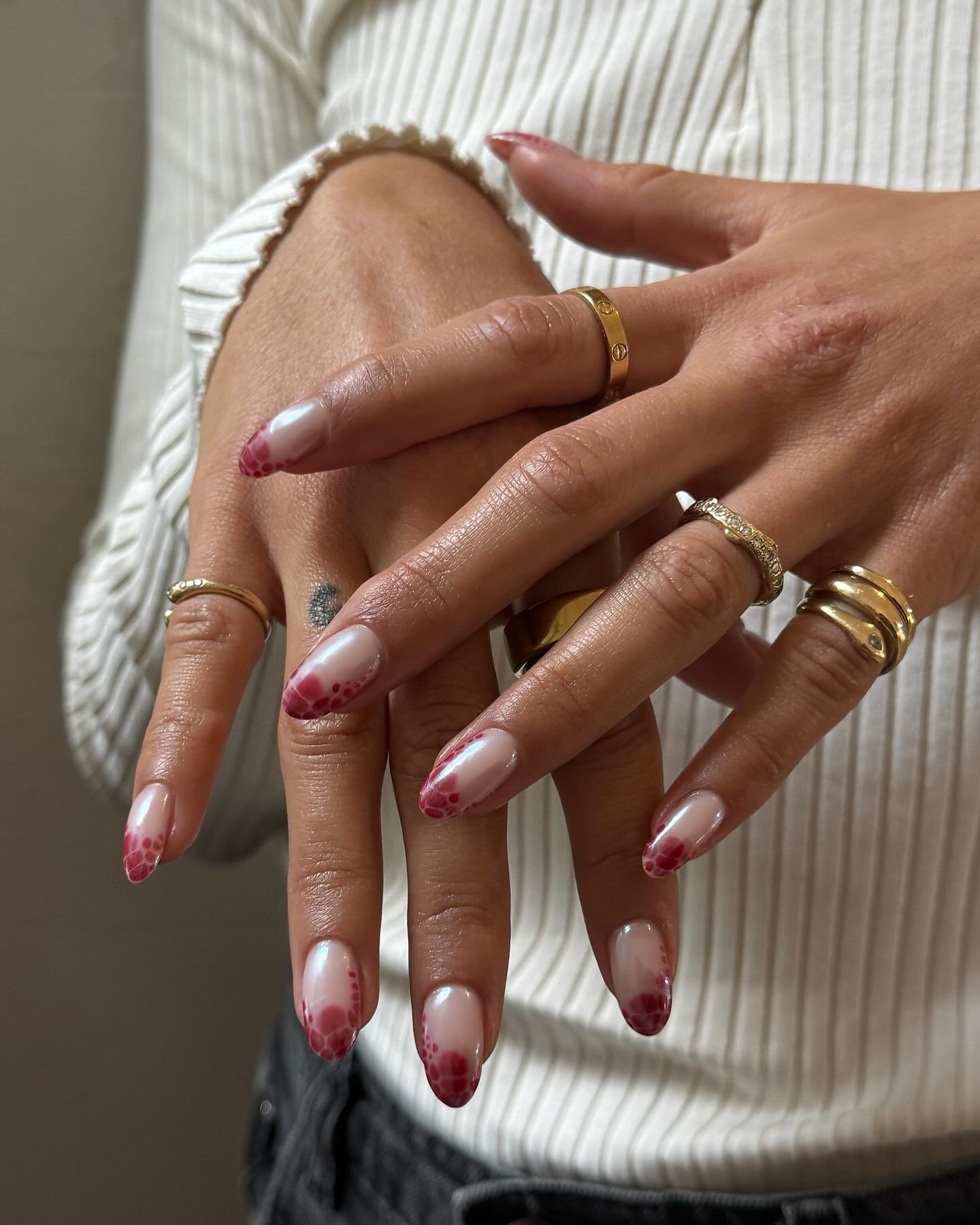 Pink reptilian French manicure.