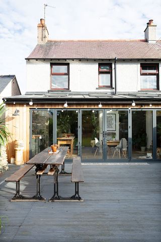 Rear extension with bi-fold doors leading to a decked terrace