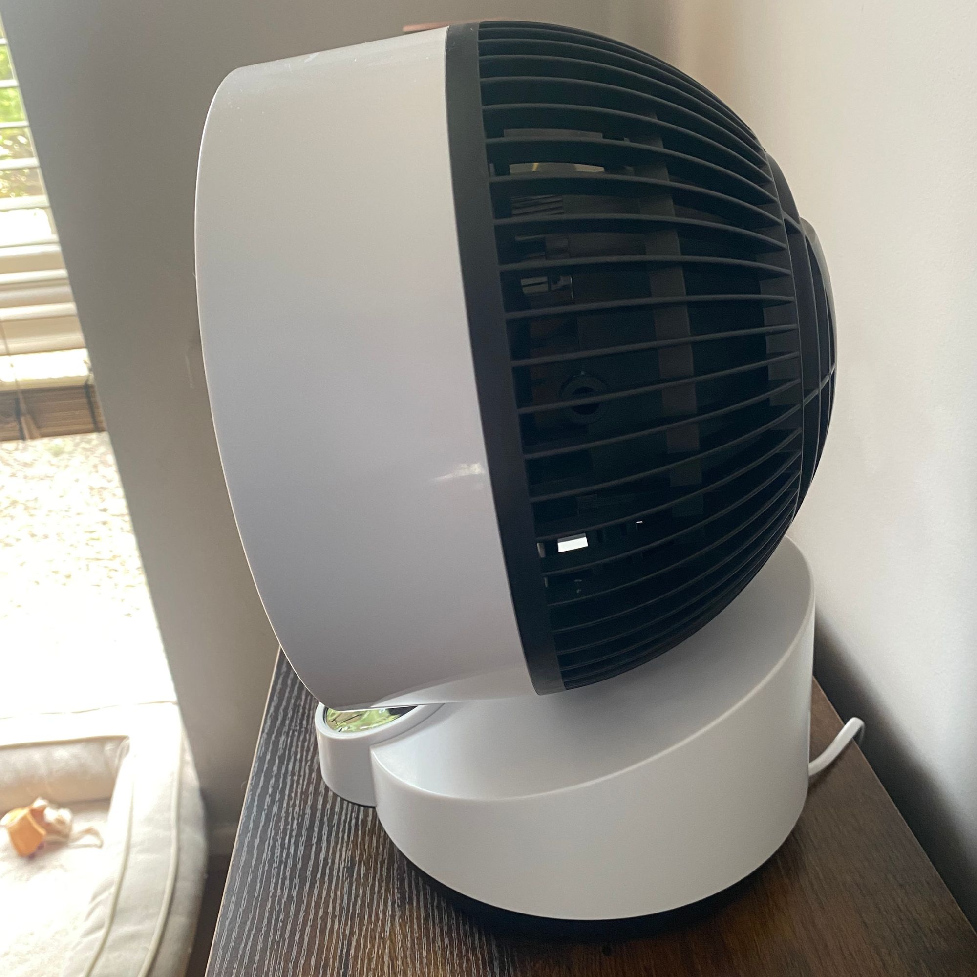 Side profile of the Vonhaus Air Circulator Cooling Fan on a side table in a neutral living room