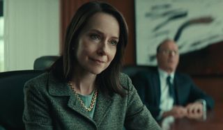 Amy Ryan listens patiently with Michael Keaton in the background in Worth.