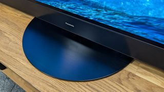 Panasonic Z95A 65-inch MLA OLED TV on wooden surface detail of TV stand