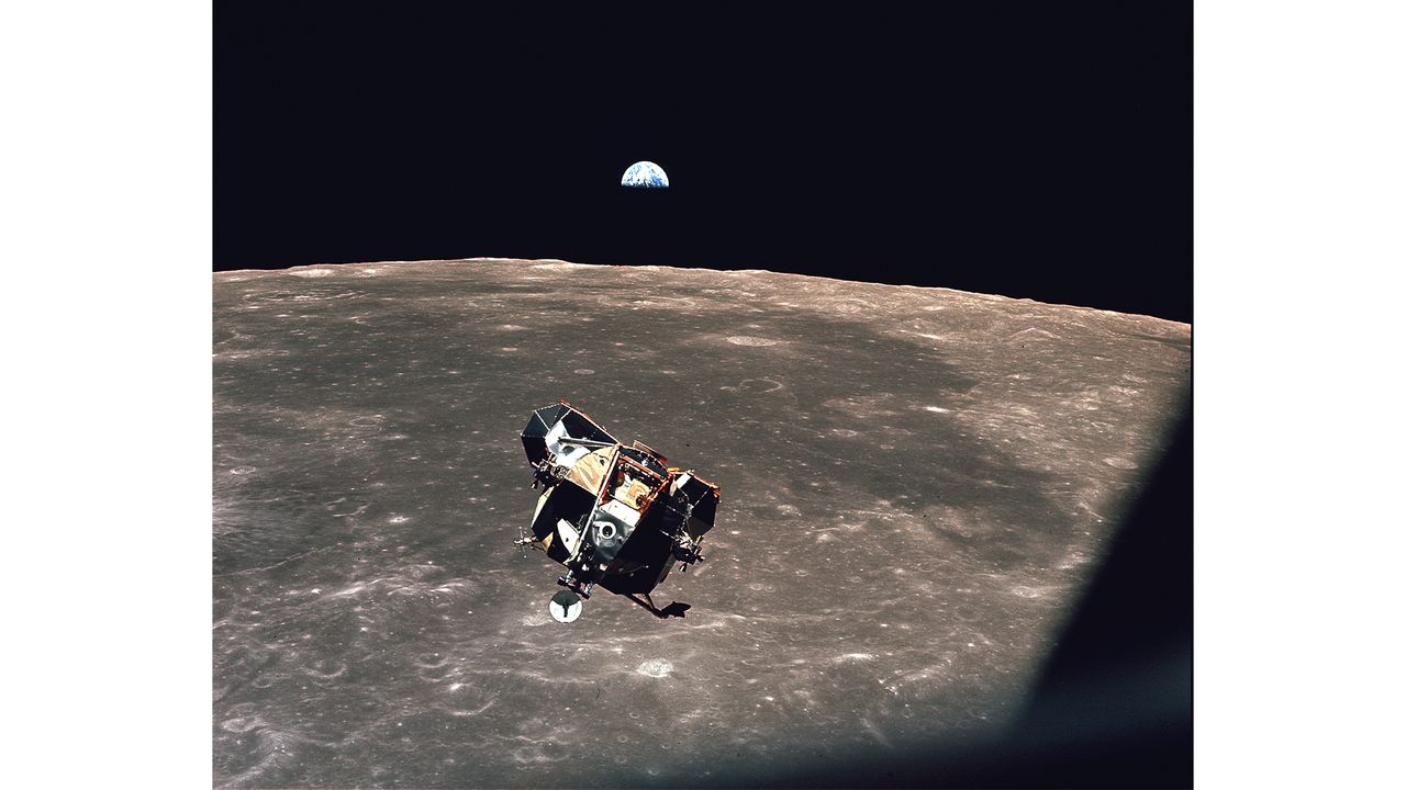 In this image, Apollo 11 astronaut Michael Collins captured the Earth with astronauts Neil Armstrong and Buzz Aldrin in the lunar module. Collins snapped this photo as the Apollo 11 lunar module "Eagle" was returning to the command module, on July 21, 1969.