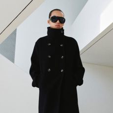 Model wears Mango cardigan with cream gloves