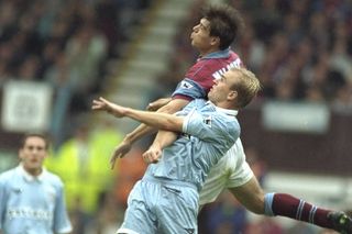 Coventry City's David Busst and Aston Villa's Savo Milosevic compete for a header in 1995.