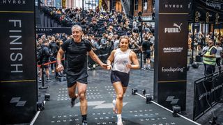 Ellë Bolland and her dad crossing the HYROX finish line