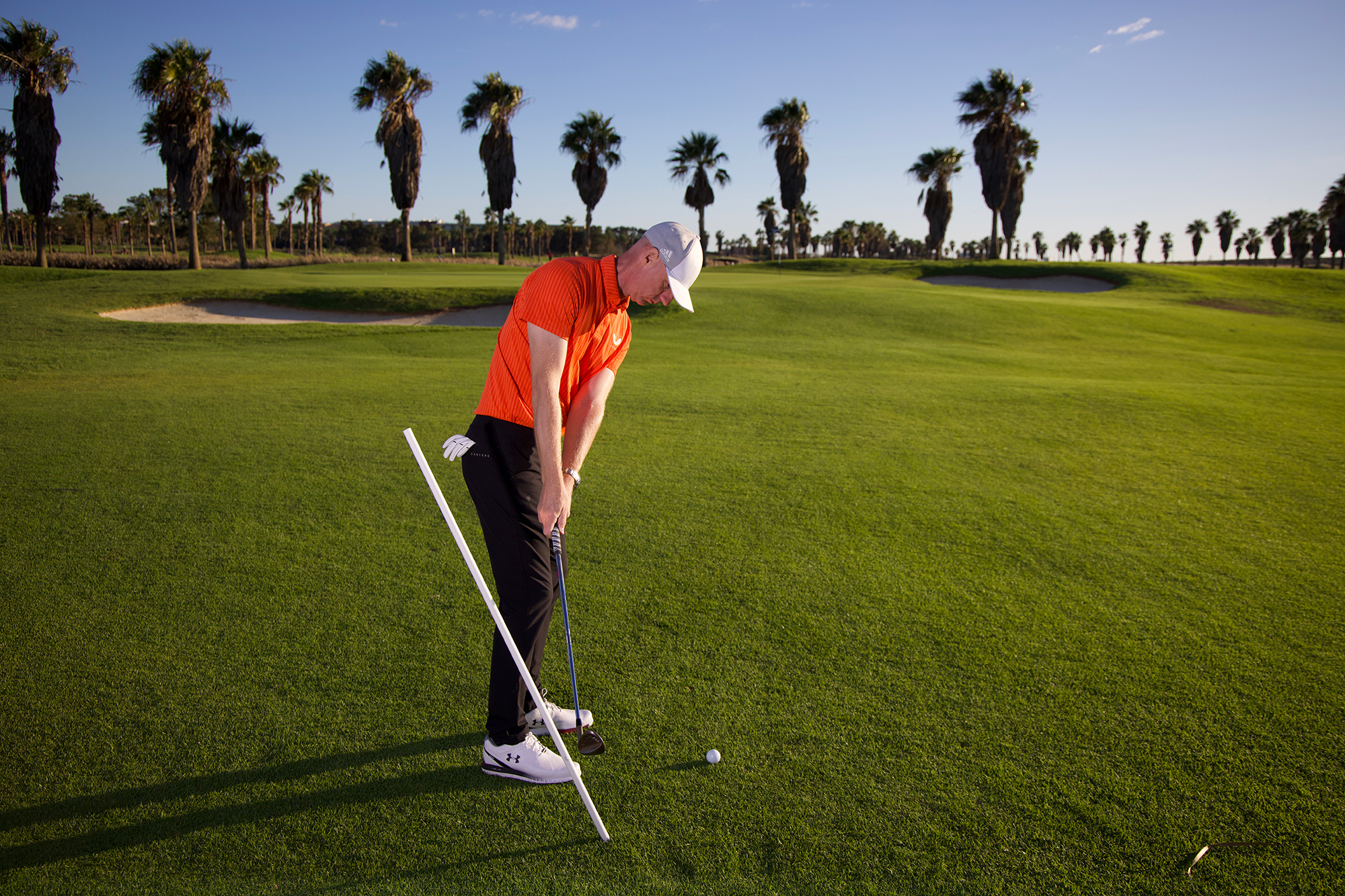 Ged Walters demonstrating the correct backswing technique using an alignment stick for instant visual feedback