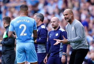 Manchester City manager Pep Guardiola with Kyle Walker during the Premier League match at The Etihad Stadium, Manchester. Picture date: Saturday September 18, 2021