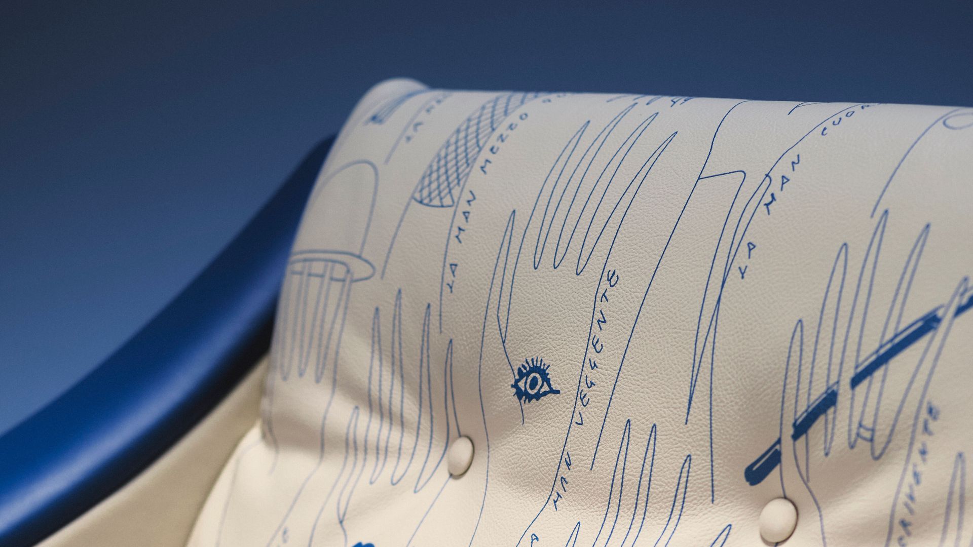 white leather armchair with blue illustrations of hands