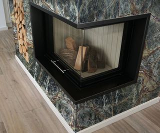 full height marble fire surround with modern log burner