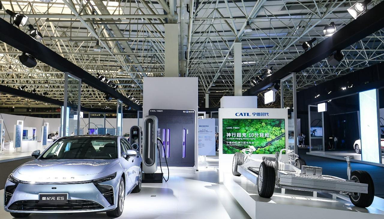 An electric car next to a CATL battery in a showroom