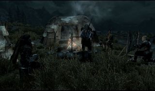 Best Skyrim mods — a number of NPCs gather for the night around their roadside campfire.