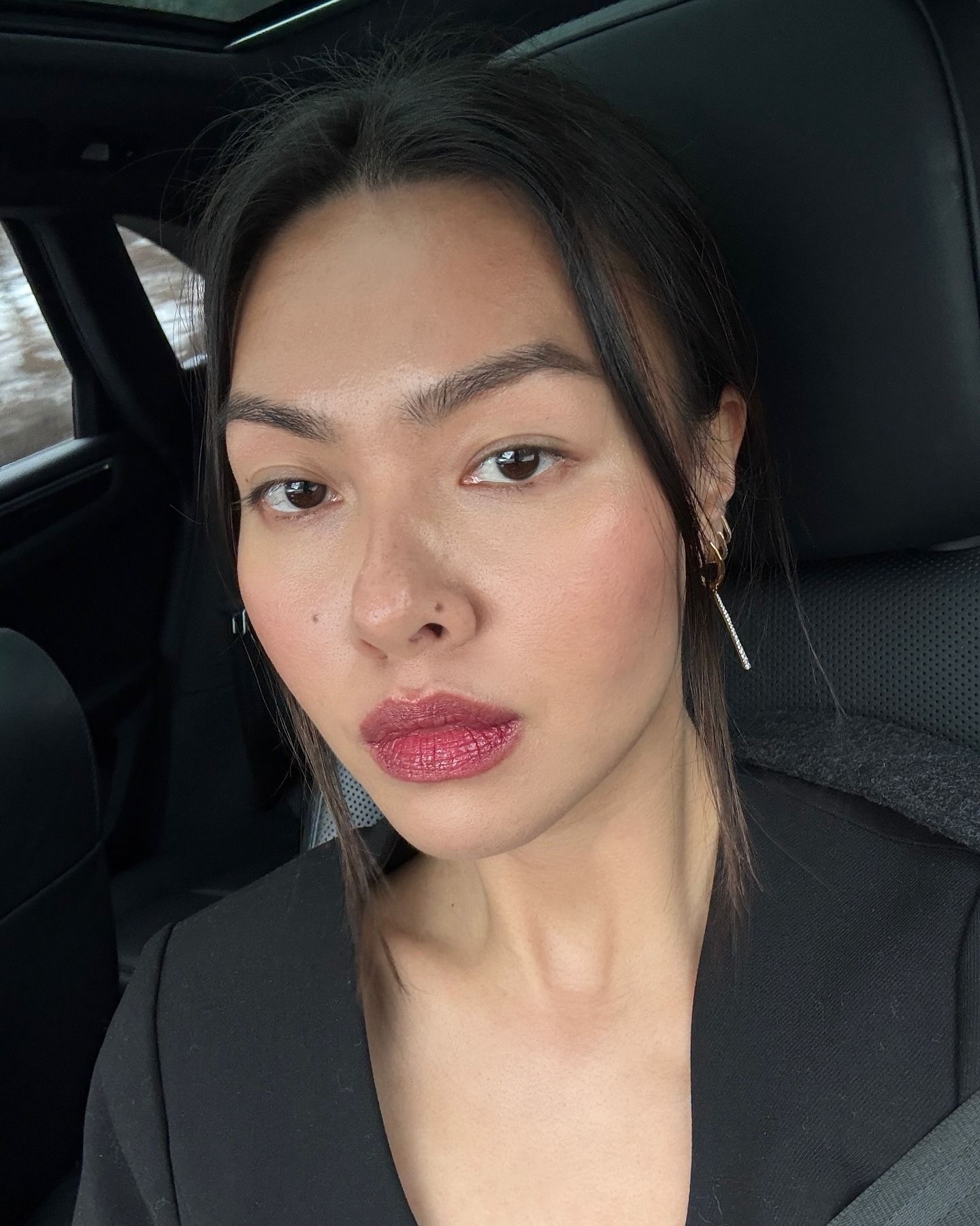Content creator @mimixn taking a car selfie wearing cherry lipstick