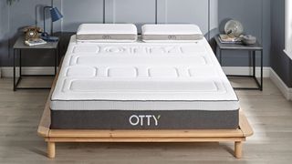 Otty Pure Hybrid Bamboo and Charcoal Mattress on a light wooden bed frame
