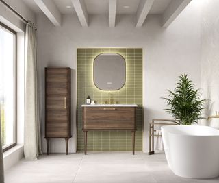 Calypso Bathrooms Marbella LED Mirror Gold Frame on green tiles in bathroom with large window, dark wooden vanity unit, cupboard and freestanding white bath