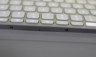 The battery cover for the Logitech Keys-to-Go 2 keyboard is fastened shut with two bolts on either end.