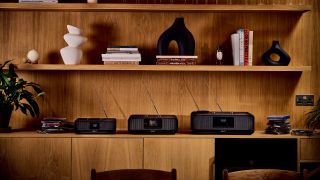 Three Roberts Revere radios on a wooden shelf